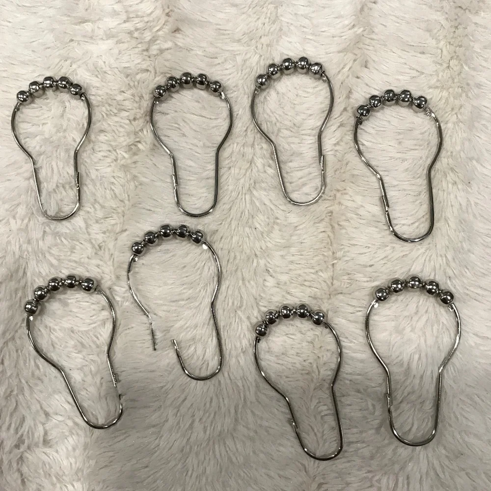 Metal hooks and bathroom shower curtain.